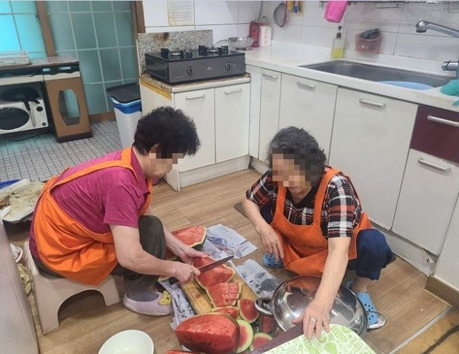 서울 영등포구 경로당에서 중식도우미 어르신들이 후식으로 대접할 수박을 자르고 있다. 영등포구 제공