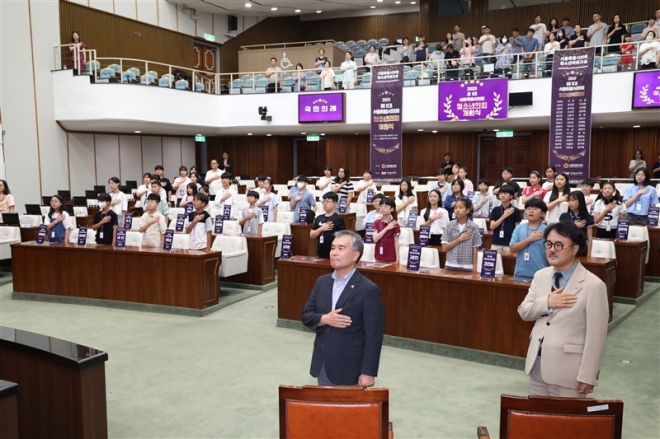 26일 열린 제1대 서울특별시의회 청소년의회 개원식에서 김현기(앞줄 왼쪽) 의장과 청소년 시의원들이 국기에 대한 경례를 하고 있다. 2023.8.27.  서울시의회 제공
