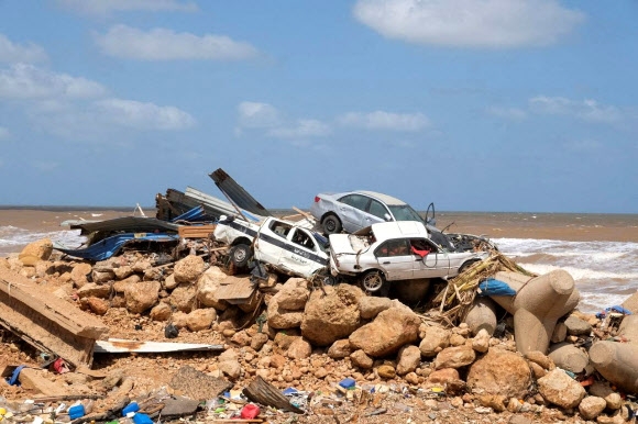 지난 9일(현지시간) 폭풍 다니엘의 여파가 큰 비가 내려 둑 두 곳이 무너지는 바람에 큰 홍수가 발생한 리비아 동부 데르나 항구 하류 언저리에 12일 물난리에 쓸려간 자동차들이 쌓여 있다. 데르나 로이터 연합뉴스
