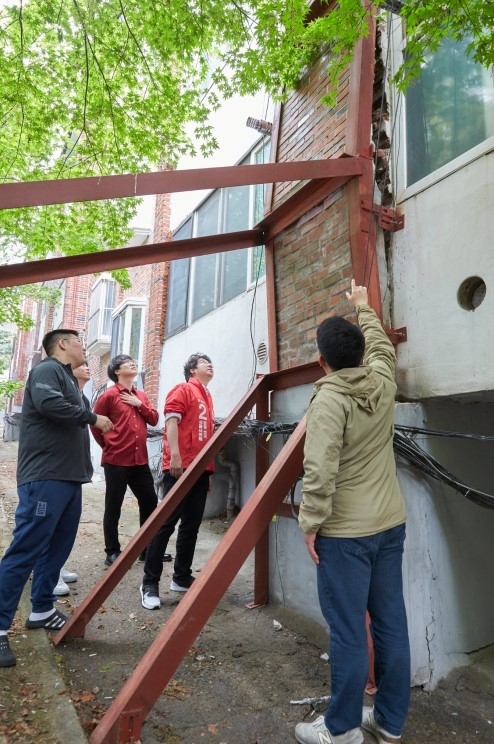 지난 2022년 사무원들과 함께 동진빌라를 방문한 당시 문성호 의원 후보. 건물의 상태는 노후되다 못해 심각했다.