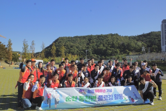 전남도시가스 직원들이 창립기념 행사 대신 순천 동천변 환경정화 운동을 한 후 기념사진을 찍고 있다.