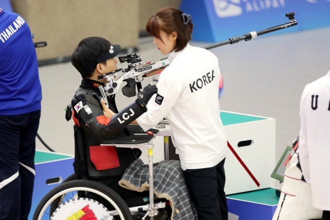 한국 사격 국가대표 이철재가 24일 중국 항저우 푸양 인후 스포츠센터에서 열린 대회 혼성 SH2 R9(50m 공기소총복사) 결선에서 로더인 아내 강혜영과 함께 경기를 펼치고 있다. 대한장애인체육회 체공