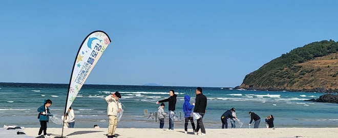 제주도가 지난 11일 제주시 조천읍 함덕해수욕장에서 고향사랑기부금 1호사업으로 남방큰돌고래 친구와 함께하는 플로깅 행사를 열었다. 이날 사전 예약을 한 사람들이 가족들과 함께 해변의 쓰레기를 줍고 있다.  제주 강동삼 기자