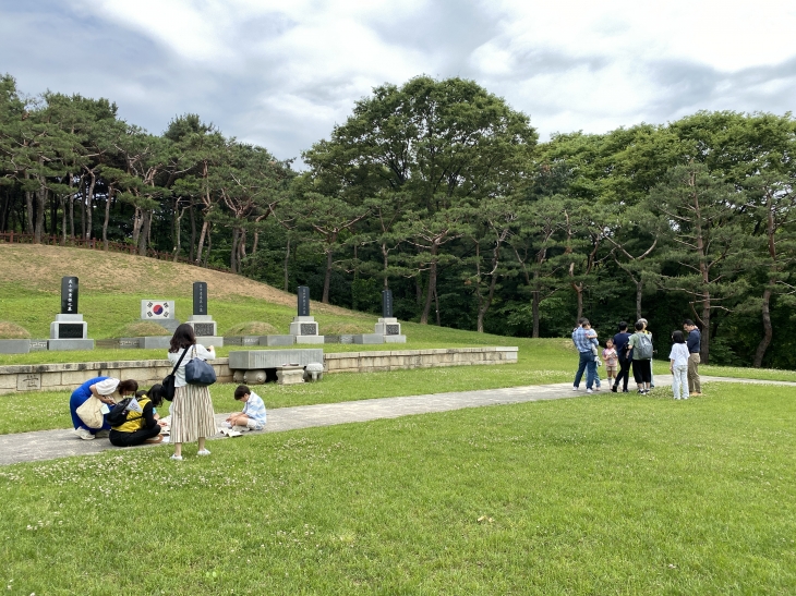 지난 25일 서울 용산구 효창공원에서 ‘도전! 21세기 한인애국단’ 프로그램 진행 중 참가자들이 삼의사 묘역 앞에서 암호를 해독하고 있다.