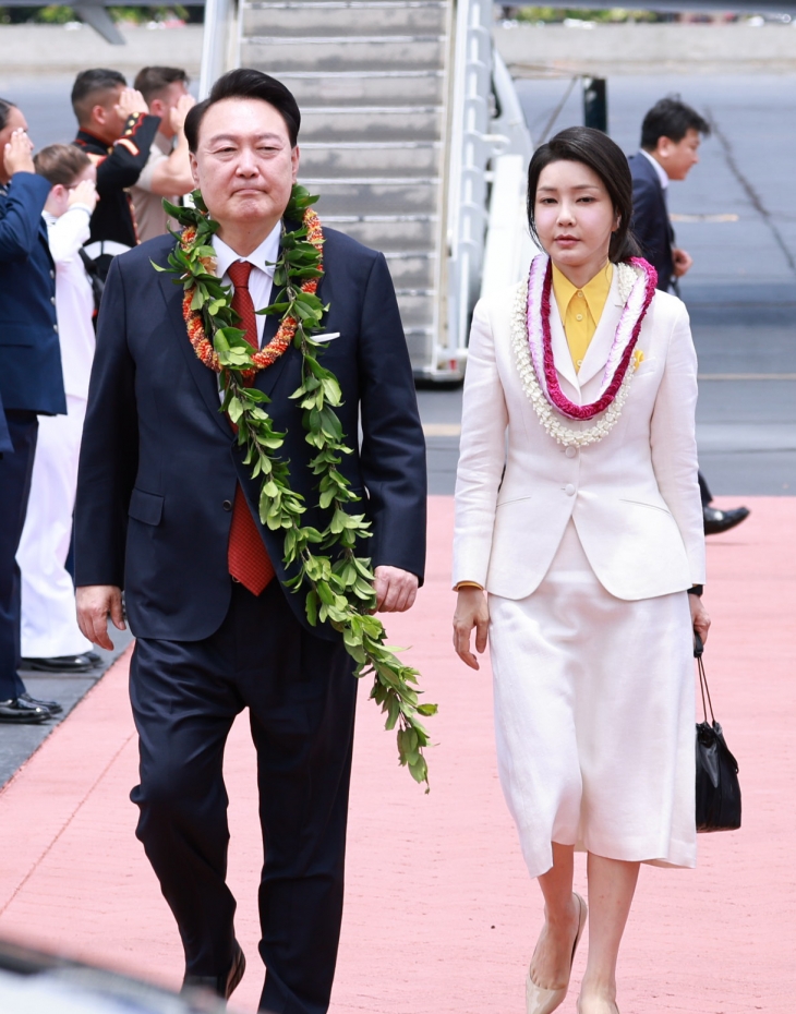 윤석열 대통령과 김건희 여사가 8일(현지시간) 나토(북대서양조약기구) 75주년 정상회의 참석에 앞서 미국 하와이 히캄 공군기지에 도착, 환영 꽃목걸이를 받고 의장대 사이로 걷고 있다. 2024.7.9 연합뉴스