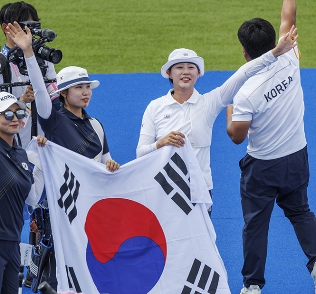 3일(현지시간) 프랑스 파리 레쟁발리드에서 열린 2024 파리올림픽 양궁 여자 개인전 결승에서 금메달을 딴 한국의 임시현(오른쪽)과 남수현(오른쪽 두 번째)이 김문정 코치와 함께 태극기를 들고 인사하고 있다. 파리 연합뉴스