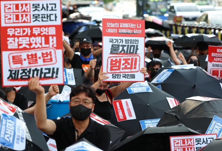 티몬·위메프(티메프) 피해 판매자와 소비자들이 18일 오후 서울 종로구 금융위원회 앞에서 ‘검은 우산 집회’를 열고 피해자 구제를 위한 특별법 제정을 촉구하고 있다. 연합뉴스