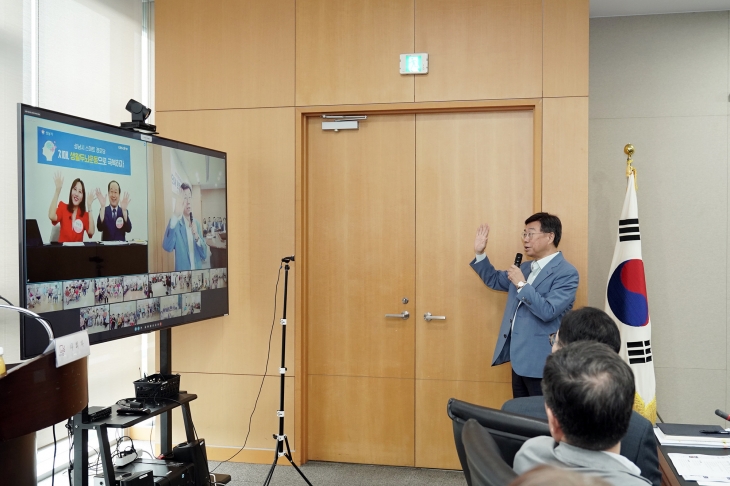 신상진 시장이 27일 시청 산성누리실에서 열린 로봇 활용 주민생활시설 돌봄 및 교육 서비스 확산 사업 2단계 착수보고회에서 화상회의시스템을 통해 경로당 회원들에게 인사를 하고있다. 성남시 제공