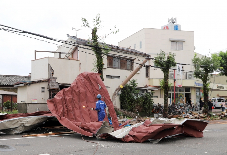 29일 제10호 태풍 산산이 지나간 일본 남서부 규슈 미야자키에서 한 작업자가 강풍으로 날아온 대형 금속판 잔해 위에 서 있다. 역대급 위력으로 평가받는 산산은 시속 15㎞로 천천히 이동하며 일본 전역에 큰 피해를 입히고 있다. 미야자키 EPA 연합뉴스