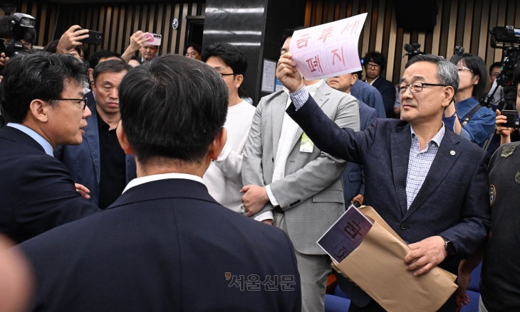 지난 24일 서울 여의도 국회에서 열린 ‘행복하고 정의로운 대한민국, 금융투자소득세 시행은 어떻게?’를 주제로 한 더불어민주당 정책 토론회에서 의원들이 방청을 막자 개인투자자 단체인 한국주식투자자연합회 회원들이 항의하고 있다. 안주영 전문기자