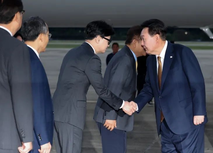 윤석열 대통령이 22일 성남 서울공항에서 체코 공식 방문을 마치고 귀국하며 마중 나온 국민의힘 한동훈 대표와 악수하고 있다.  연합뉴스