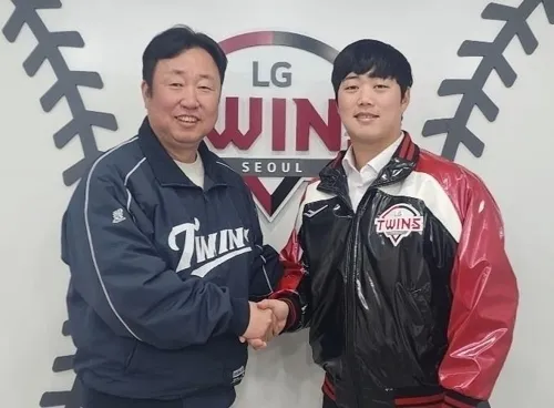 LG 트윈스 함덕주가 지난해 12월 24일 원소속팀과 계약기간 4년 총액 38억원에 자유계약선수(FA) 협상을 완료한 뒤 차명석 단장과 기념사진을 찍고 있다. LG 트윈스 제공