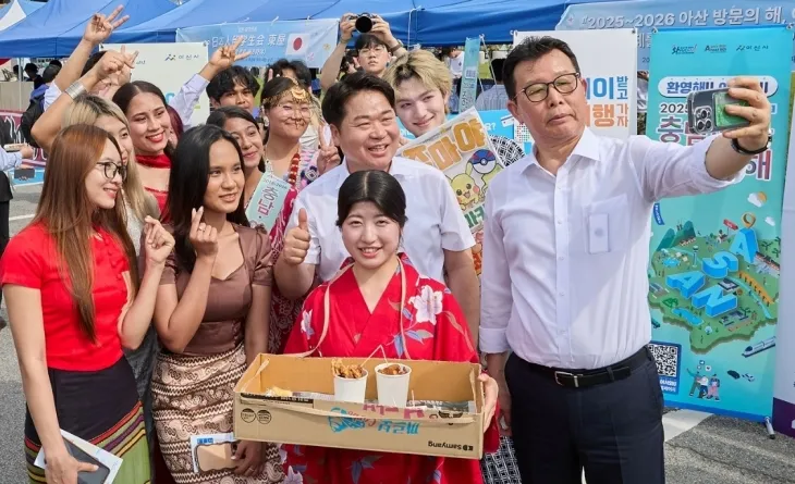 오세현 아산시장과 문성제 선문대 총장이 글로컬 다문화 축제장에서 유학생들과 셀카 촬영을 하고 있다. 시 제공