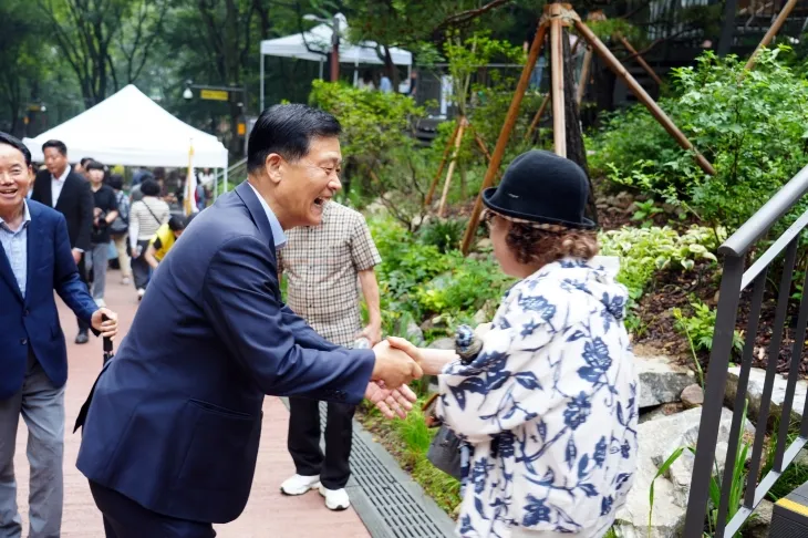 이승로(왼쪽) 서울 성북구청장이 지난 16일 열린 ‘오동 물빛정원’ 준공식에서 만난 지역 주민과 대화를 나누고 있다. 성북구 제공
