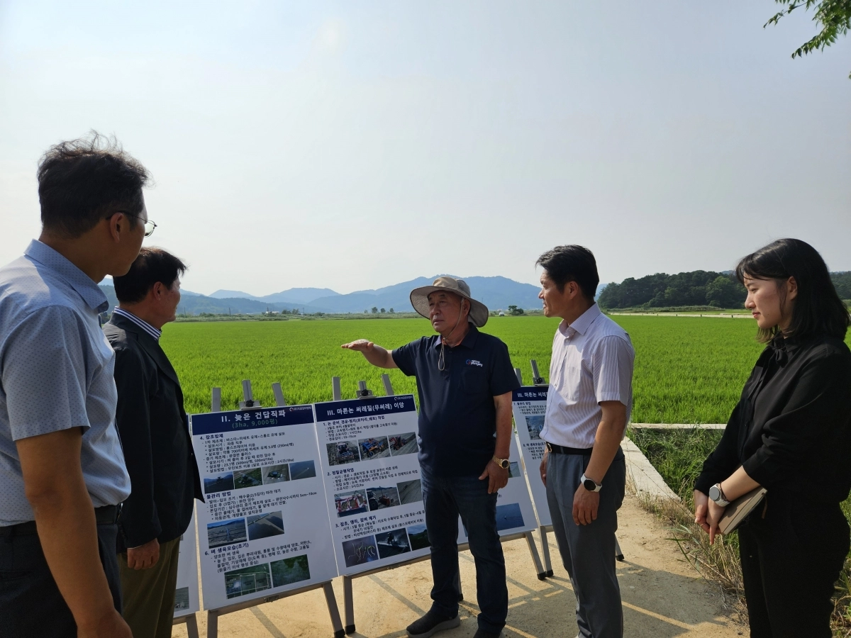 지난 8일 김식(가운데) 지금강이엔지 회장이 전남 나주시 동강면 들녘에서 김병원 전 농협회장 등 농업관계자들에게 대형화된 첨단농지 설명회를 갖고 있다. 지금강이엔지 제공
