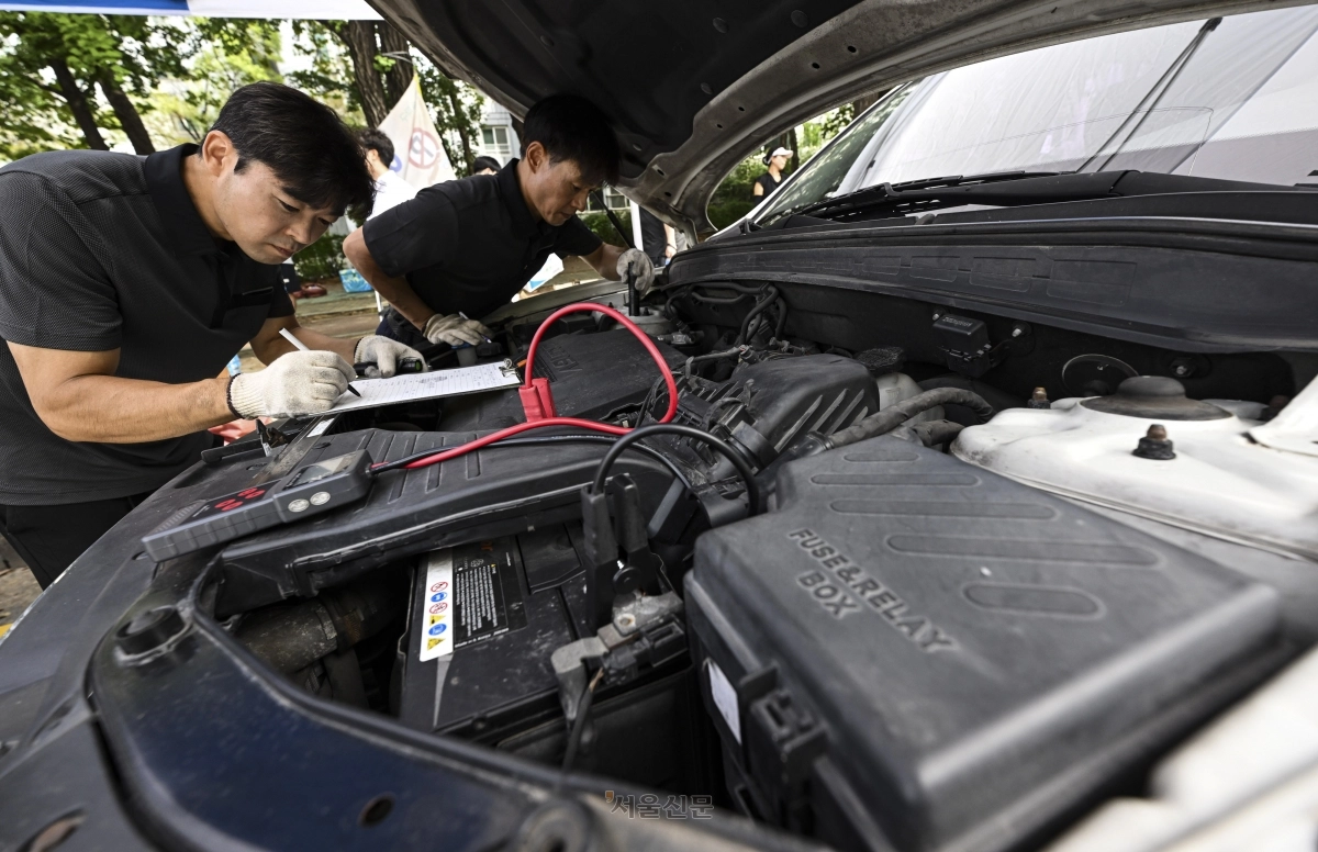 14일 서울 송파구 올림픽공원사거리 인근에서 서울시 자동차전문정비사업조합(카포스) 송파구지회 정비사들이 추석 연휴를 앞두고 차량 무상점검을 하고 있다. 2025.9.14 이지훈 기자
