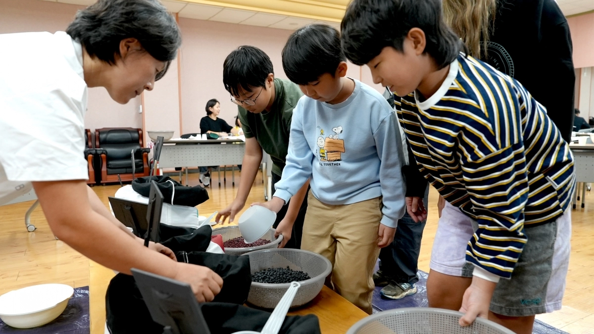 25일 애월도서관에서 열린  2026 제주비엔날레의 사전 워크숍 체험프로그램의 하나로 초등학생들이 콩베개 만들기에 도전하고 있다. 제주도립미술관 제공
