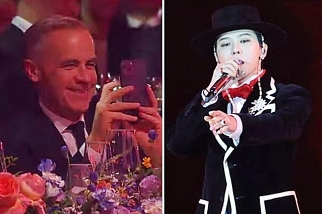 마크 카니(왼쪽) 캐나다 총리가 31일 경북 경주 라한셀렉트호텔 대연회장에서 열린 ‘2025 APEC 정상회의’ 환영 만찬 공연 무대에 오른 가수 지드래곤을 휴대폰 카메라로 촬영하고 있다. 2025.10.31 연합뉴스TV 화면