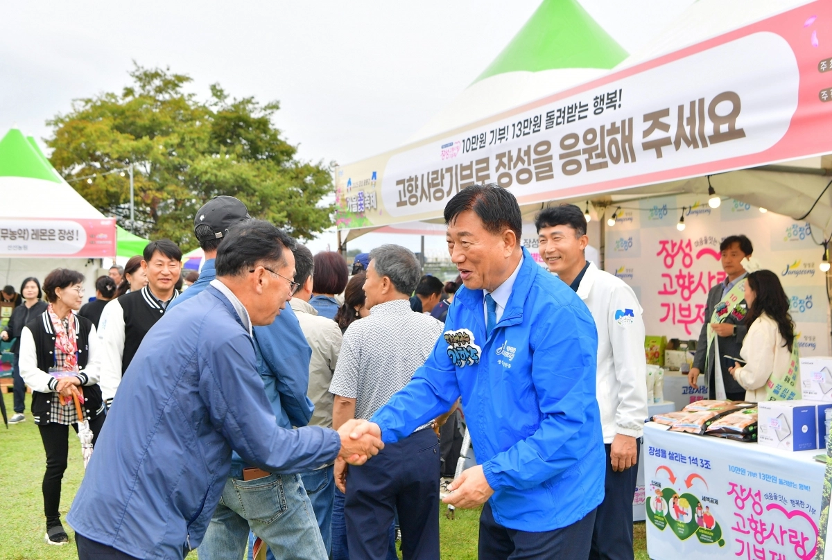 2025년 10월 황룡강 가을꽃축제 기간 고향사랑기부제 홍보부스를 찾은 김한종 장성군수가 방문객을 반기고 있다. (장성군 제공)