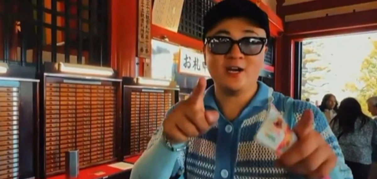 일본 도쿄 사찰 센소지에서 복채함에 가짜 지폐(저승 돈)를 넣으려는 중국인 관광객.