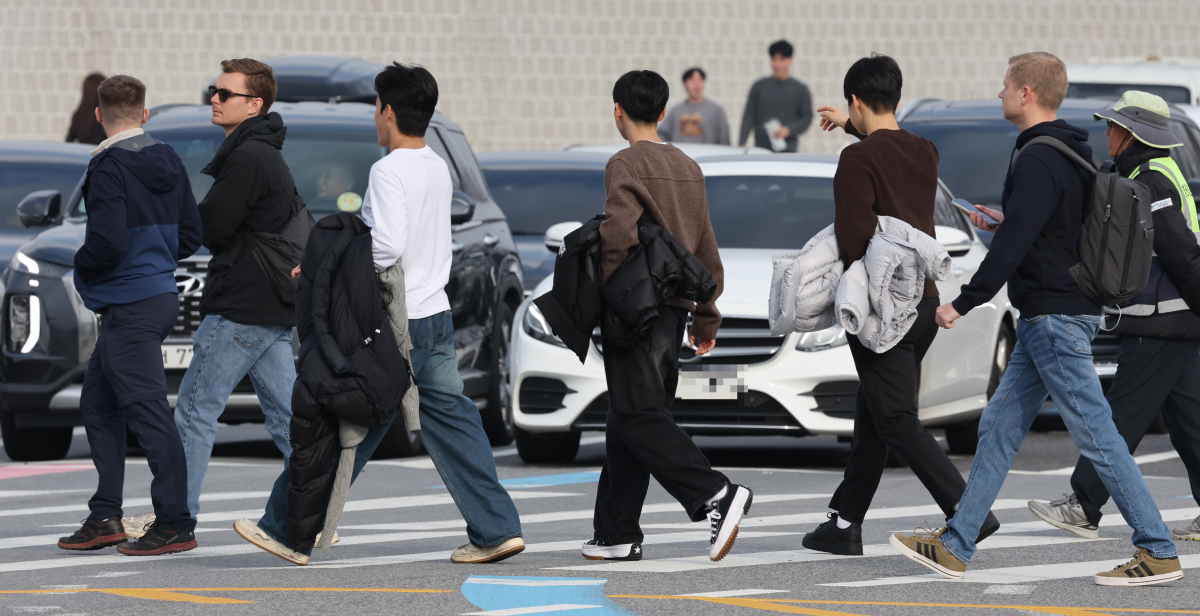 30일 낮 최고기온이 20도까지 오르는 등 비교적 포근한 날씨가 이어지는 가운데 이날 서울 종로구 광화문 광장에 나들이 나온 시민들이 한손에 겨울 외투를 들고 이동하고 있다. 기상청에 따르면, 이날 강원 영동을 제외한 중부지방과 제주도는 대체로 흐리겠고 그 밖의 지역에는 가끔 구름이 많은 가운데 기온은 평년보다 높겠다고 밝혔다. 오는 2일 부터는 전국 대부분 지역이 영하권에 머무를 예정이다. 2025.11.30. 뉴시스