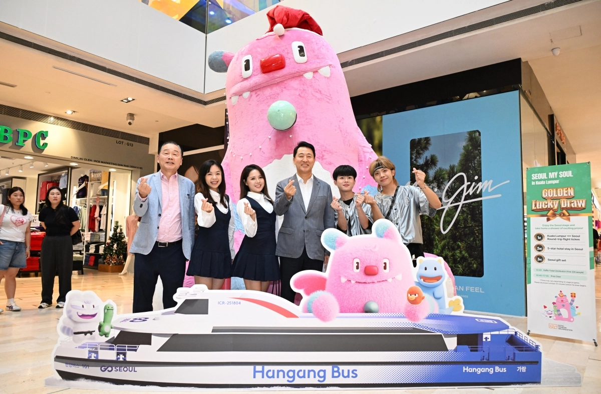 오세훈 서울시장이 7일(현지시간) 말레이시아 쿠알라룸푸르 파렌하이트88에서 열린 ‘서울관광 홍보행사‘에 설치된 대형 해치 앞에서 K-팝 커버댄스 팀과 기념사진을 찍고 있다. 서울시 제공