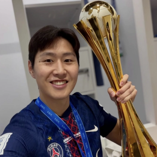 이강인(PSG)이 18일 (한국시간) 카타르 알라이얀의 아흐메드 빈 알리 스타디움에서 열린 브라질 플라멩구와의 2025 국제축구연맹(FIFA) 인터콘티넨털컵 결승에서 팀이 승리한 뒤 받은 트로피를 들고 기념사진을 찍고 있다.