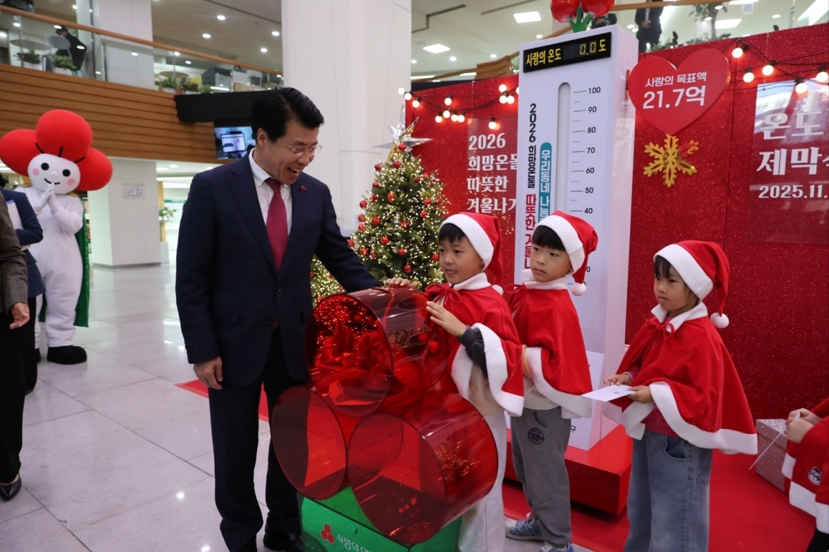 서강석(왼쪽) 서울 송파구청장이 지난 11월 14일 구청 청사 1층에서 열린 ‘사랑의 온도탑’ 제막식에서 성금을 전달한 아이들을 보며 활짝 웃고 있다. 송파구 제공