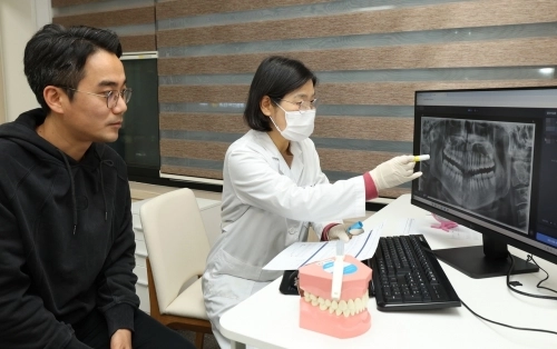 서울 노원구 보건소 치과의사가 주민에게 구강 건강 검진 결과를 설명하고 있다.   노원구 제공
