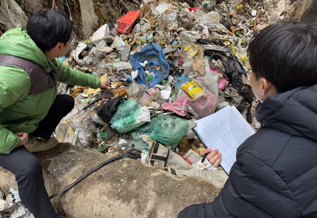충남 천안시 공무원들이 지난 8일 천안의 한 폐기물 소각업체에서 쓰레기 더미를 뒤지며 수도권 생활폐기물 불법 반입 여부를 점검하고 있다. 천안시 제공