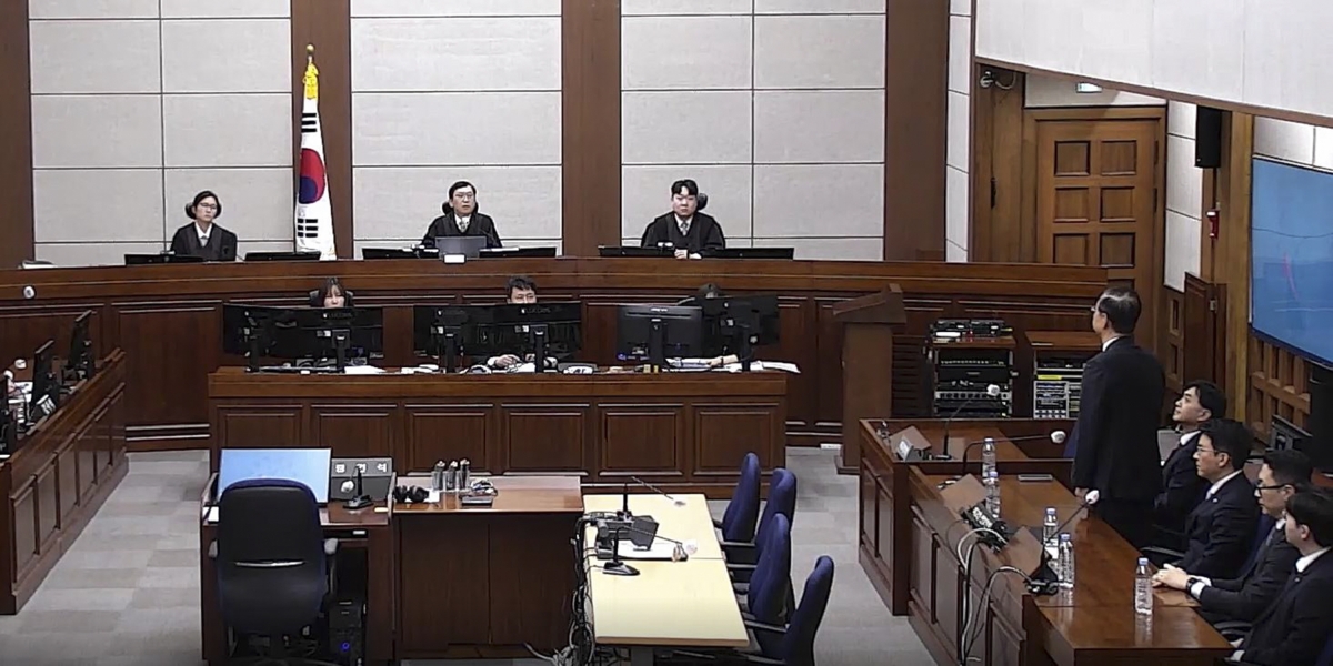 한덕수 전 국무총리가 21일 서울 서초구 서울중앙지법에서 열린 1심 선고 공판에서 징역 23년형을 선고받은 후 재판부의 질문에 답변하고 있다. 이날 법원은 “최후진술에 이르러서야 죄송스럽게 생각한다는 취지로 진술하였지만 그 사과의 진정성을 인정하기 어렵다”며 한 전 총리를 법정구속했다. 서울중앙지방법원 제공