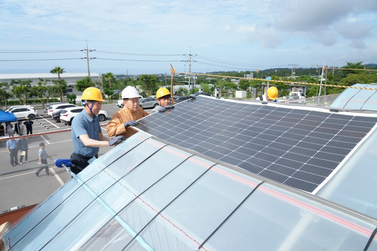 오영훈 제주도지사가  지난 7월 가진 민생로드에서 서귀포시 강정동 농업기술원 태양광 이용 RE100 감귤생산 모델 실증 시설을 둘러보고 필름형 태양광 패널 설치 작업에 직접 참여하고 있다. 제주도 제공