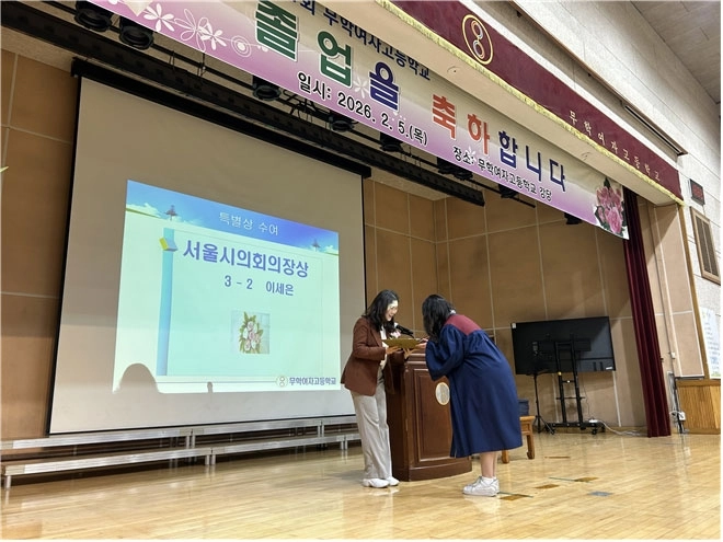 구미경 서울시의원이 무학여고 모범졸업생에게 서울시의회 의장상을 수여하고 있다.
