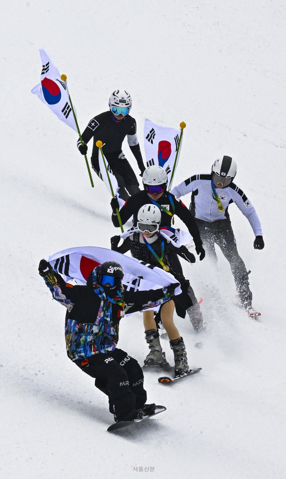 스키어들이 10일 경기 광주시 곤지암리조트 스키장에서 쇼트트랙, 피겨 등의 복장을 차려입고 태극기를 든 채 동계올림픽 국가대표를 응원하는 퍼포먼스를 하고 있다. 2026.2.10 이지훈 기자