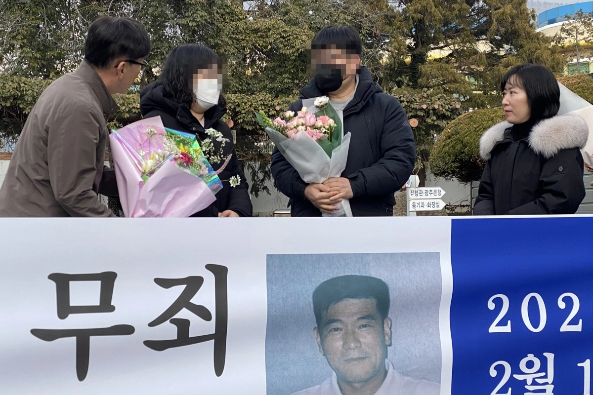 11일 오후 전남 해남군 해남읍 광주지법 해남지원 법정 앞에서 보험금을 노려 아내를 살해한 혐의로 무기징역을 받았던 고(故) 장동오 씨의 유족이 재심 무죄 선고에 따른 축하 꽃다발을 받고 있다. 광주지법 해남지원은 이날 재심 사건 선고 공판에서 ‘진도 저수지 살인사건’ 피고인 장씨에게 핵심 증거의 위법 수집 등을 이유로 무죄를 선고했다. 연합뉴스