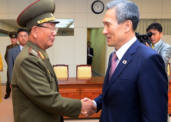 김관진(오른쪽) 청와대 국가안보실장과 황병서 북한 총정치국장이 2015년 8월 25일 남북 고위급회담에서 악수하고 있다. 통일부 제공