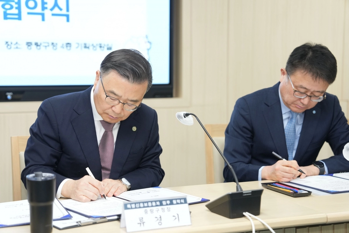 류경기(왼쪽) 서울 중랑구청장이 지난해 3월 지역 중소기업 지원을 위한 ‘특별신용보증 융자지원 협약식’에서 서명하고 있다. 중랑구 제공