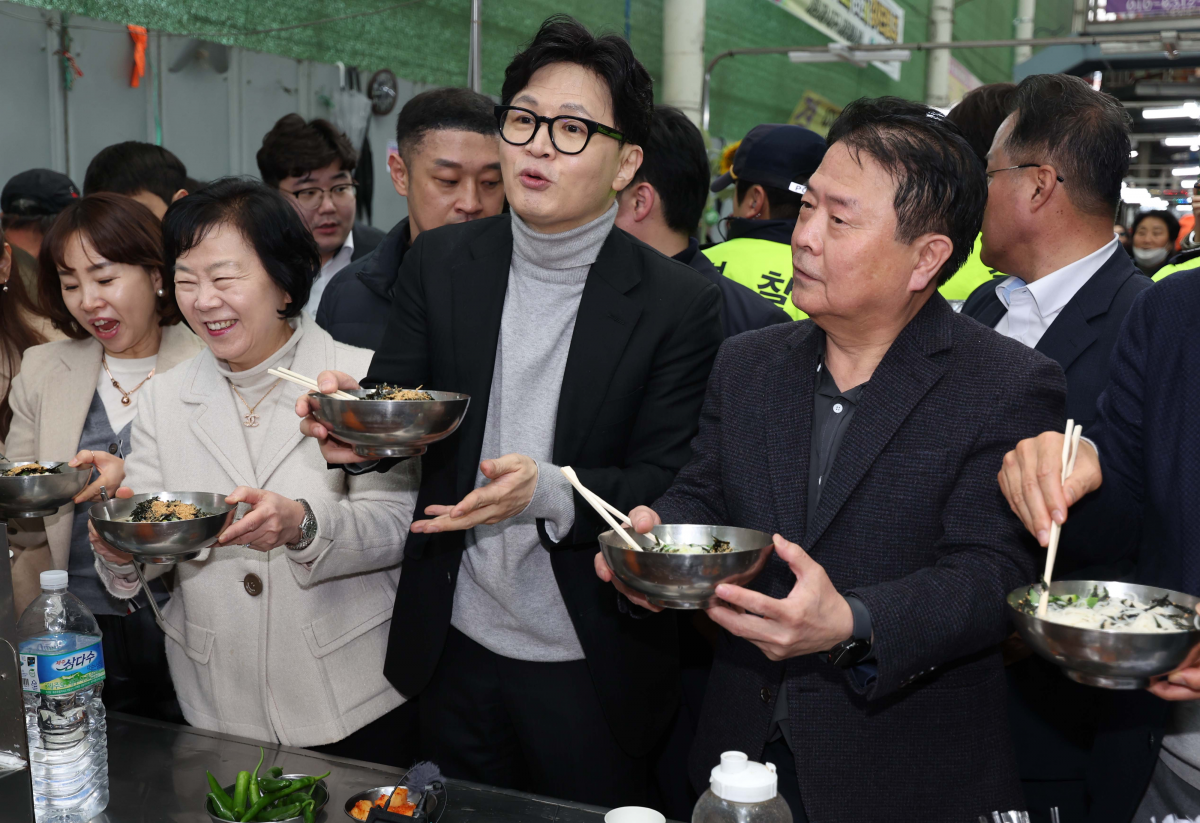 한동훈 국민의힘 전 대표가 27일 오후 대구 서문시장을 찾은 자리에서 일행들과 국수를 먹고 있다. 대구 연합뉴스