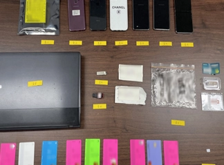 A씨 일당의 자금세탁에 동원된 대포계좌와 대포폰. 서울동부지검 제공