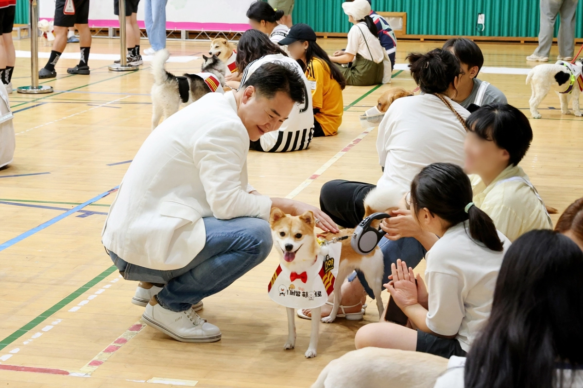 오언석(가운데) 도봉구청장이 2024년 7월 반려견 동반 방범대 선포식에서 구민의 반려견을 쓰다듬고 있다. 도봉구 제공