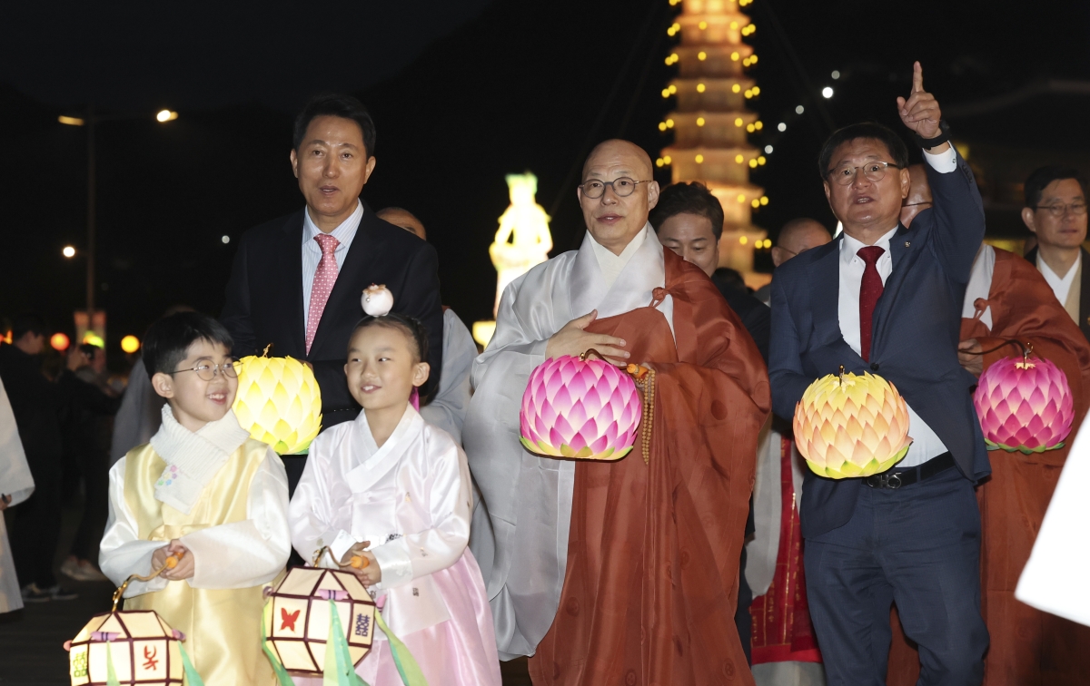 진우 스님(뒷줄 왼쪽에서 두 번째)과 오세훈(뒷줄 왼쪽 첫 번째) 서울시장이 함께 탑돌이를 하고 있다.. 뉴시스.