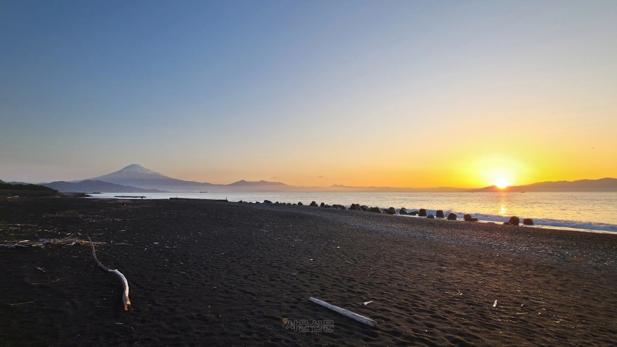 검은 모래와 흑송숲으로 유명한 일본 시즈오카 남단의 미호노 마쓰바라 공원 모습. 동틀녘에 더 검게 느껴지는 모래와 햇살을 받아 검붉게 변한 후지산이 절경을 펼쳐 내고 있다.