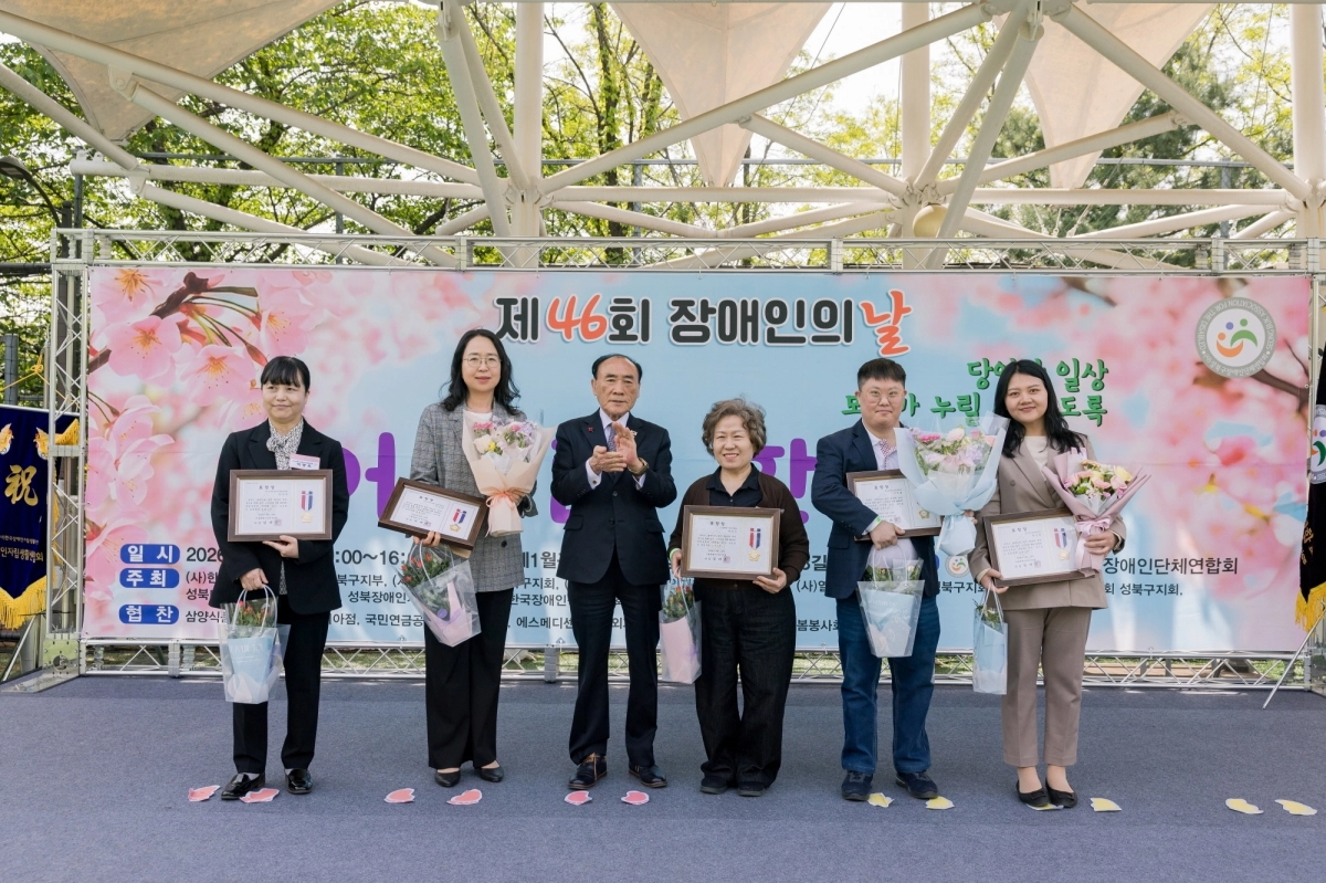 임태근(왼쪽 세 번째) 성북구의장이 지난 23일 성북구 제1월곡인조잔디구장에서 열린 제46회 장애인의 날 기념행사에서 유공자 표창을 받은 참가자들과 기념 촬영을 하고 있다. 성북구 제공