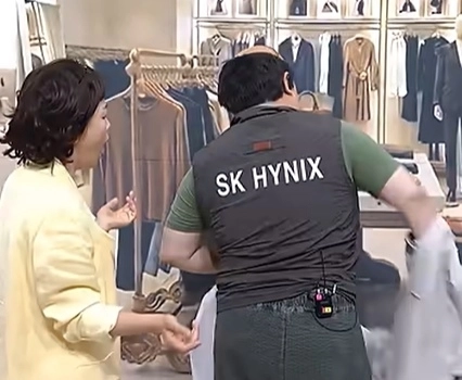 지난 25일 공개된 쿠팡플레이 시리즈 ‘SNL 코리아 시즌 8’에서 배우 김규원이 허름한 차림으로 백화점 명품관에 들어서자 점원 정이랑이 난색을 표했지만, 김규원이 점퍼를 벗어 안에 입고 있던 SK하이닉스 회사 조끼를 드러내자 정이랑이 반색하고 있다. 자료 : 쿠팡플레이