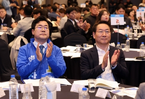 박찬대 더불어민주당 인천시장 예비후보와 유정복 국민의힘 인천시장 예비후보가 4월 30일 인천 중구 하버파크호텔에서 열린 한국노총인천지역본부 노동절 기념대회에 참석해 박수치고 있다.  뉴시스