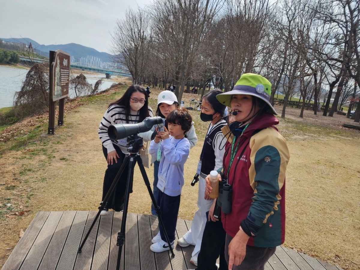 울산 철새탐조 해설사(오른쪽)가 태화강을 찾은 방문객들에게 철새의 특성을 설명하고 있다. 울산시 제공