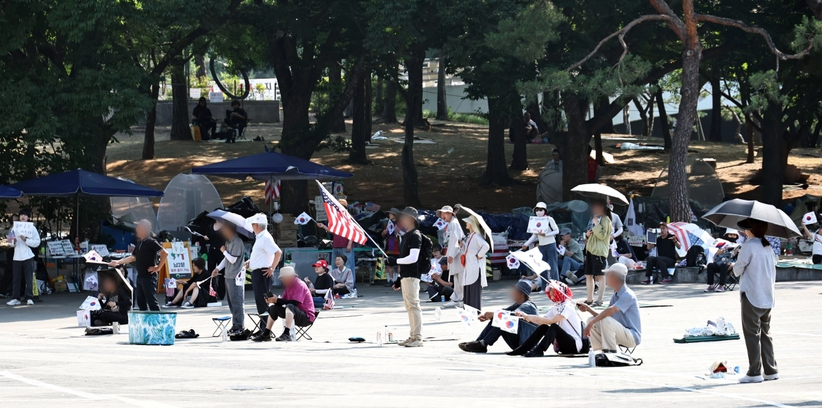 6·3 지방선거 투표용지 부족 사태로 인한 ‘개표소 봉쇄 시위’가 계속되고 있는 18일 서울 송파구 올림픽공원 핸드볼경기장 출입문 앞에서 참가자들이 구호를 외치고 있다. 연합뉴스