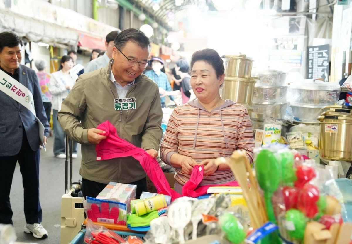 류경기(왼쪽) 중랑구청장이 ‘면목시장’에서 장을 보고 있다. 중랑구 제공