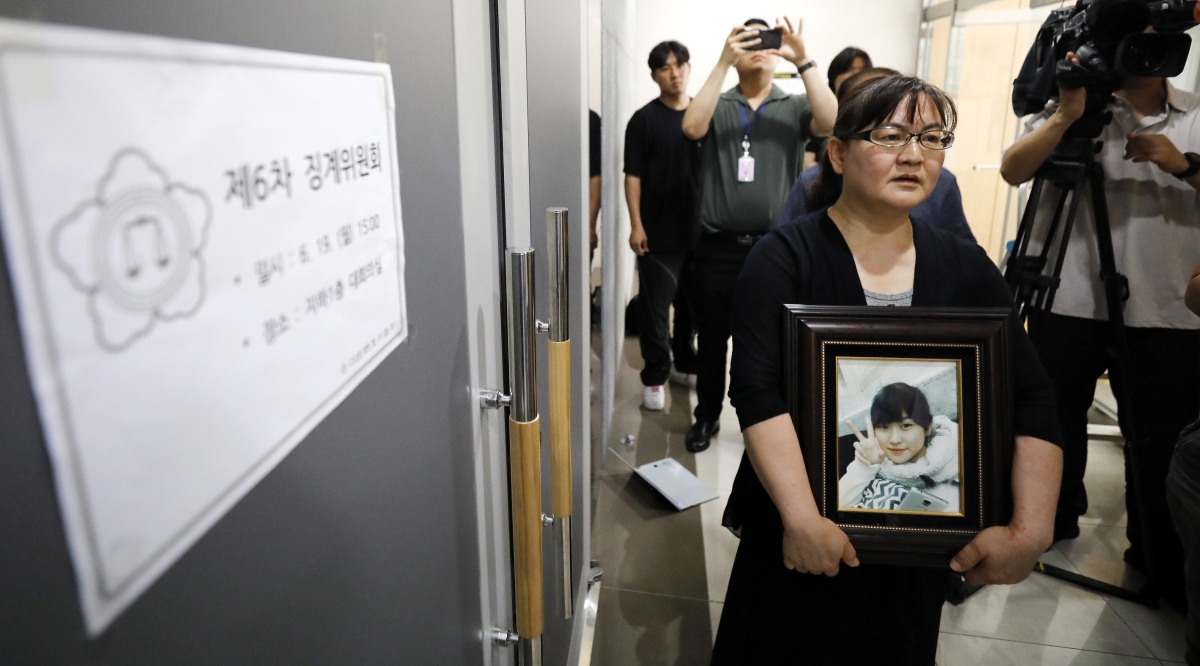 권경애 변호사에 대한 대한변호사협회의 징계위원회가 열린 지난 2023년 6월 19일 학교폭력 피해자 유족 이기철씨가 권 변호사의 영구 제명을 촉구하며 딸의 영정 사진을 들고 위원들을 기다리고 있다. 권씨가 법정에 3회 불출석하면서 이씨가 제기한 학교폭력 손해배상 소송 항소심은 ‘항소취하 간주’ 처리됐다. 뉴스1