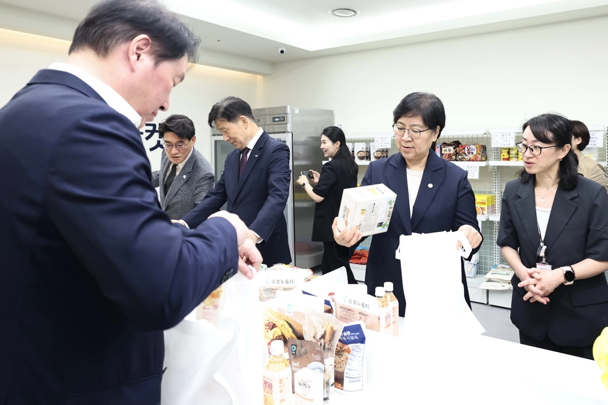 정은경 보건복지부 장관(오른쪽 사진 왼쪽)과 최태원 대한상공회의소 회장이 20일 화성특례시 나래울복지관 그냥드림에서 그냥드림 꾸러미를 만들고 있다. 화성시 제공